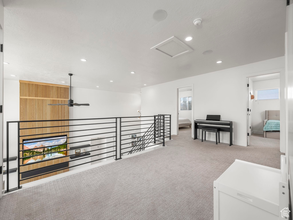 Hall featuring carpet floors, attic access, and recessed lighting