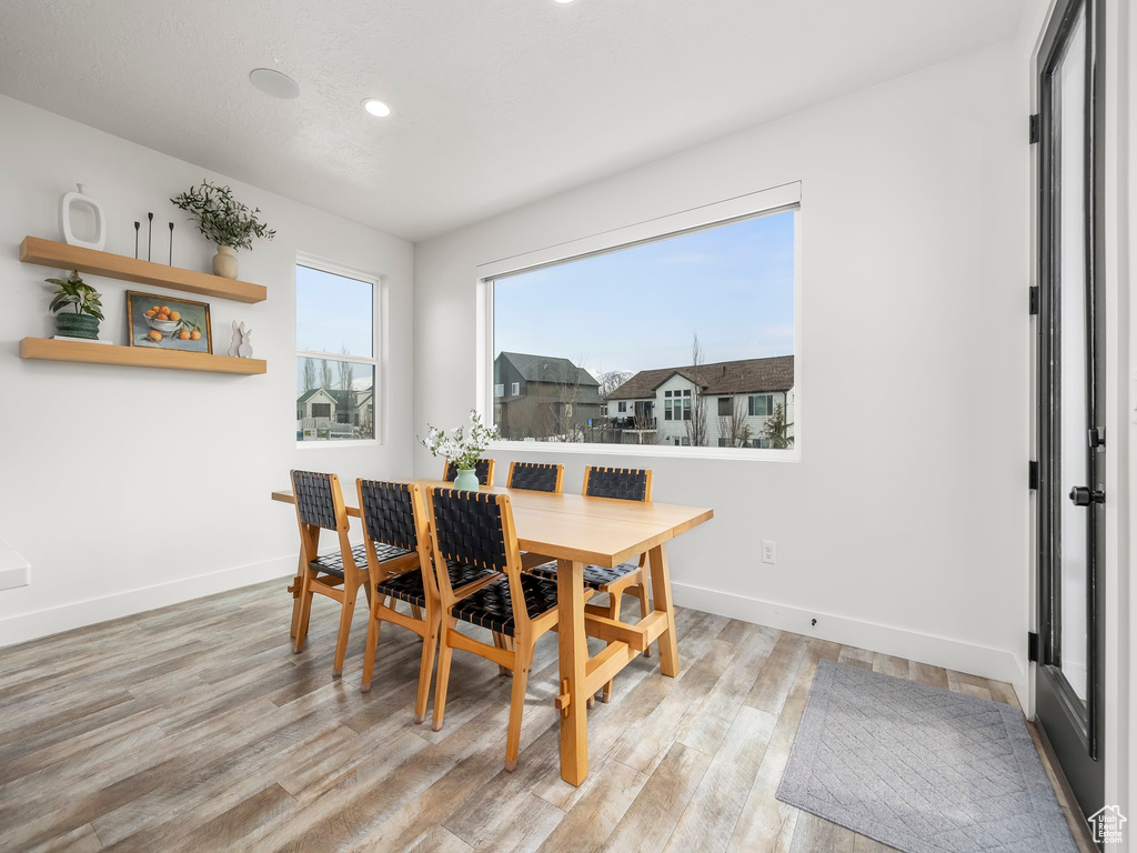 Dining area featuring light wood-style flooring, baseboards, and recessed lighting