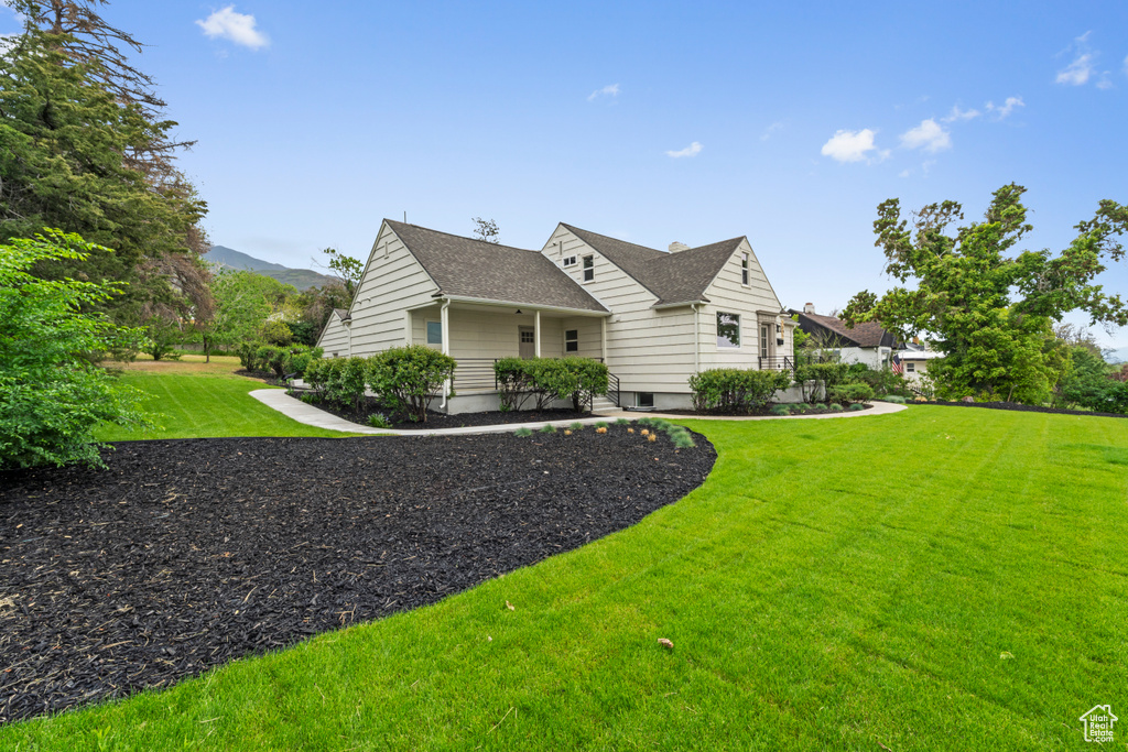 View of side of property with a yard
