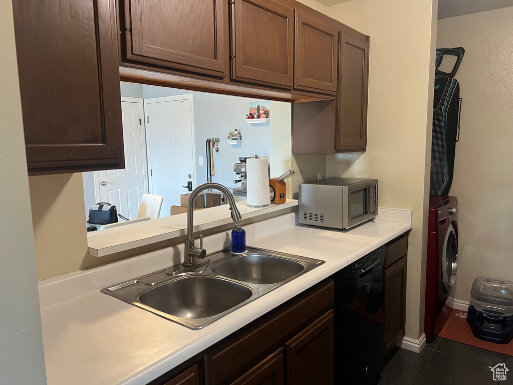 Kitchen with light countertops, washing machine and clothes dryer, a sink, dishwasher, and dark brown cabinets