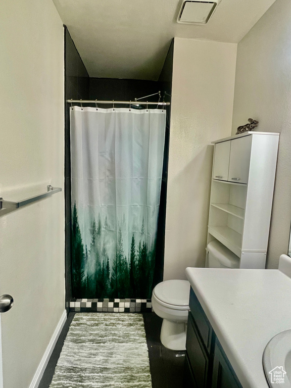 Bathroom with visible vents, baseboards, toilet, vanity, and a shower with curtain