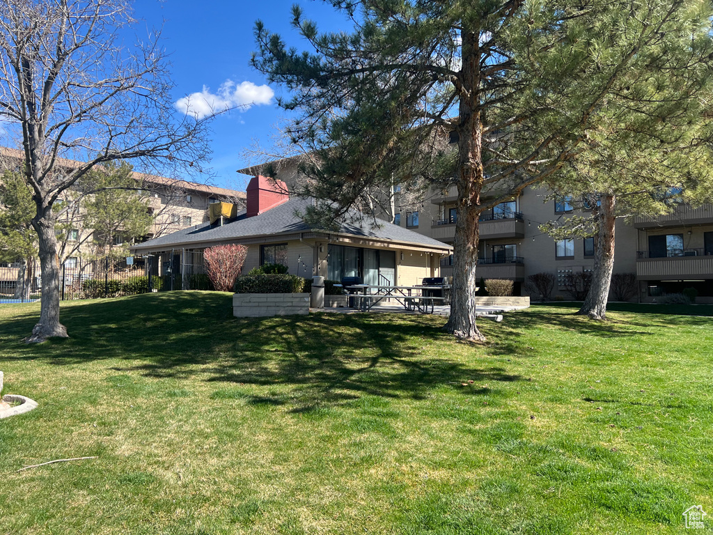 Back of property with a yard