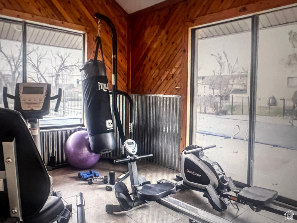Workout area featuring wood walls