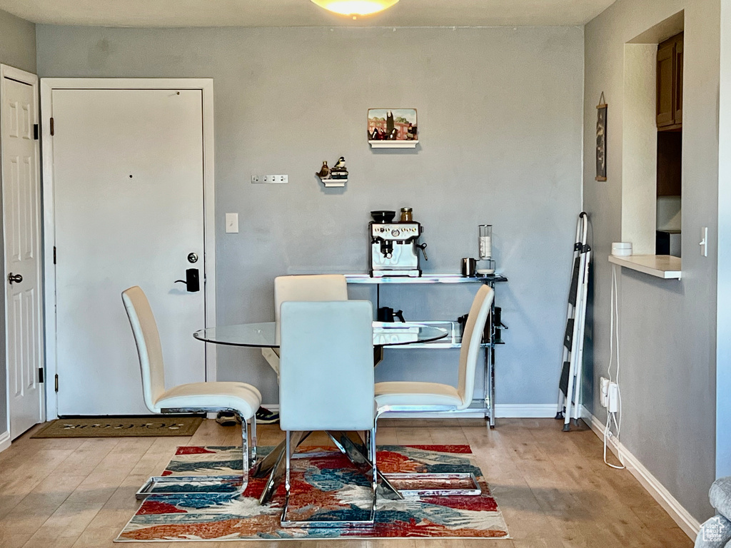 Dining room with baseboards and light wood-style flooring