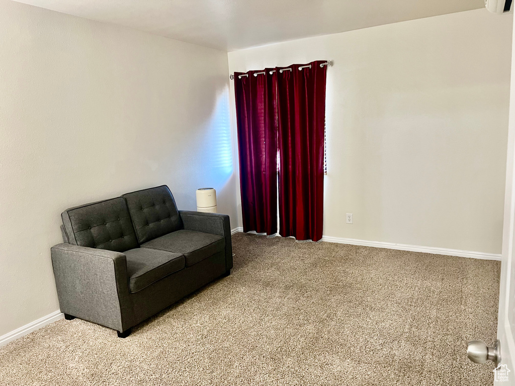 Living area with carpet flooring and baseboards