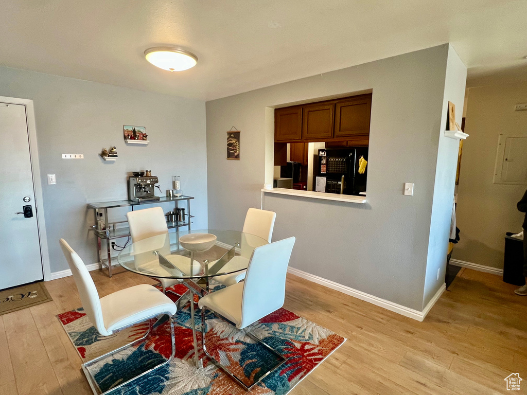Dining room with baseboards and light wood-style flooring