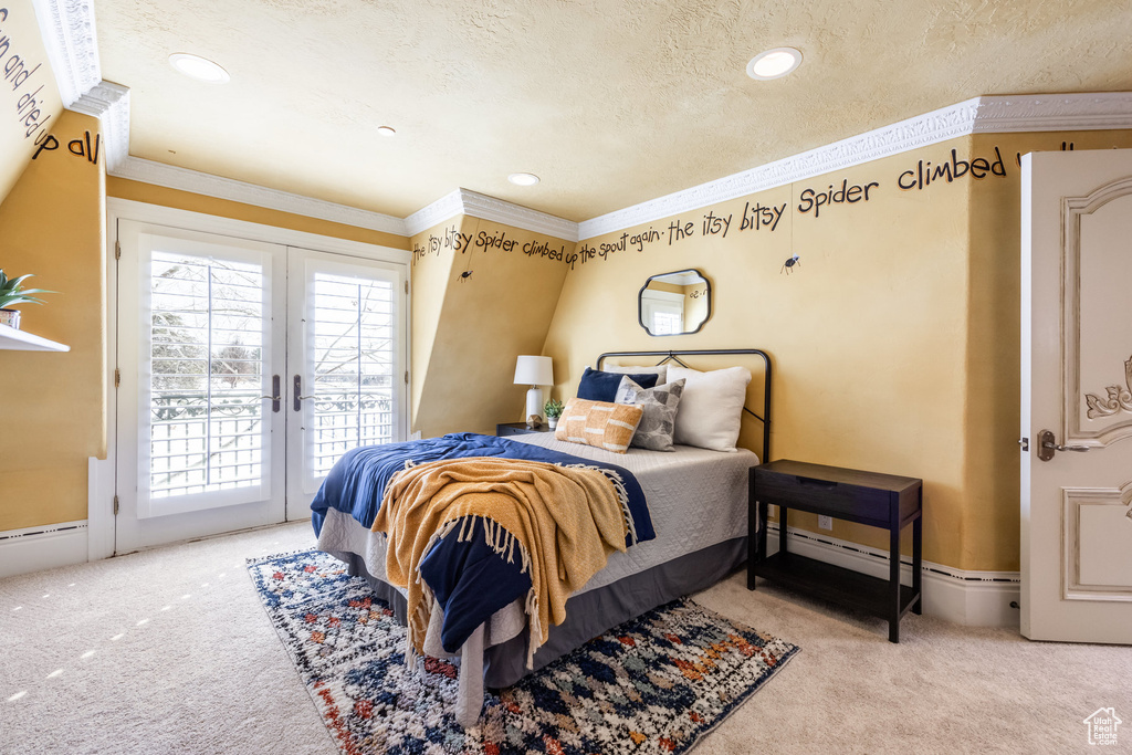 Carpeted bedroom with a textured ceiling, crown molding, access to outside, recessed lighting, and french doors