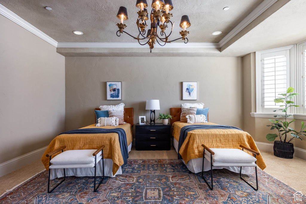 Carpeted bedroom with baseboards, a textured ceiling, a chandelier, and crown molding
