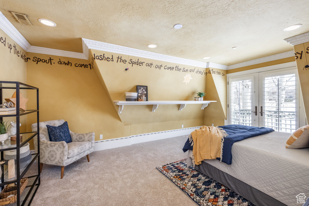 Carpeted bedroom featuring access to exterior, crown molding, french doors, a textured ceiling, and visible vents