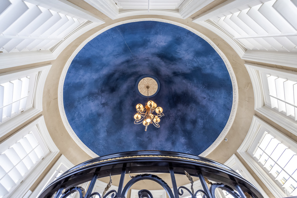 Interior details featuring crown molding and a chandelier