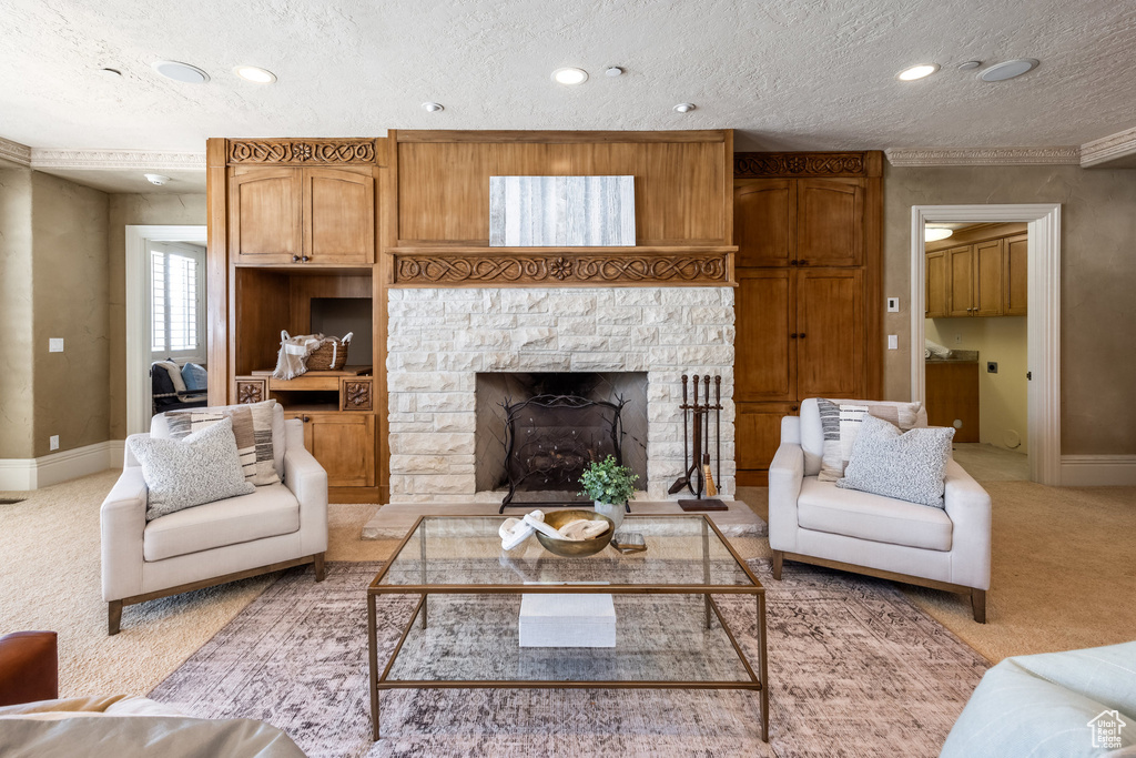Living room featuring baseboards, a textured ceiling, and light colored carpet