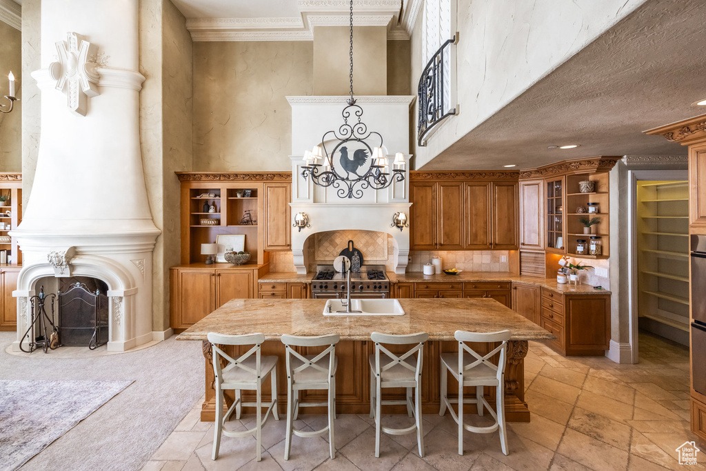 Kitchen featuring stone tile floors, a fireplace, and brown cabinets