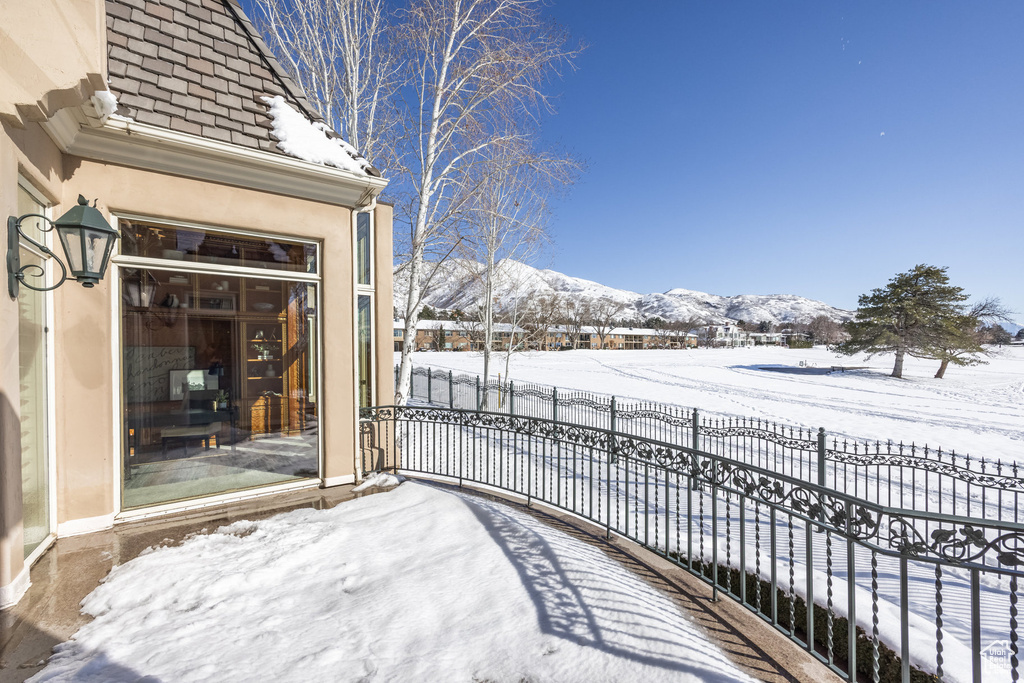 Snow covered deck with a mountain view