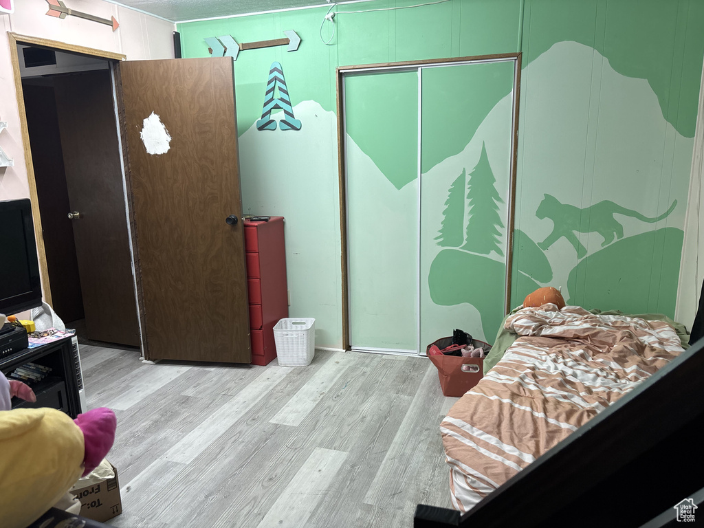 Bedroom with a closet and wood finished floors