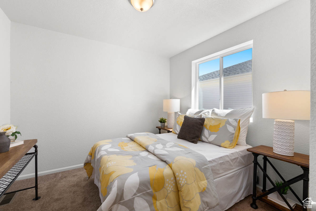 Bedroom featuring carpet floors and baseboards