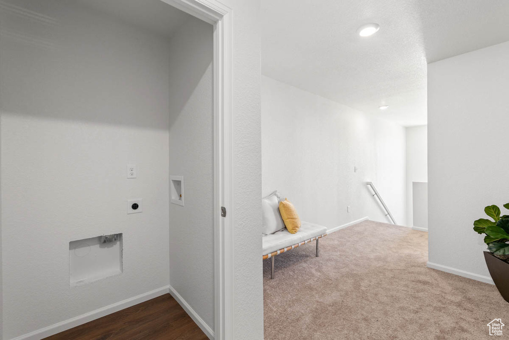 Hall featuring an upstairs landing, baseboards, and dark carpet