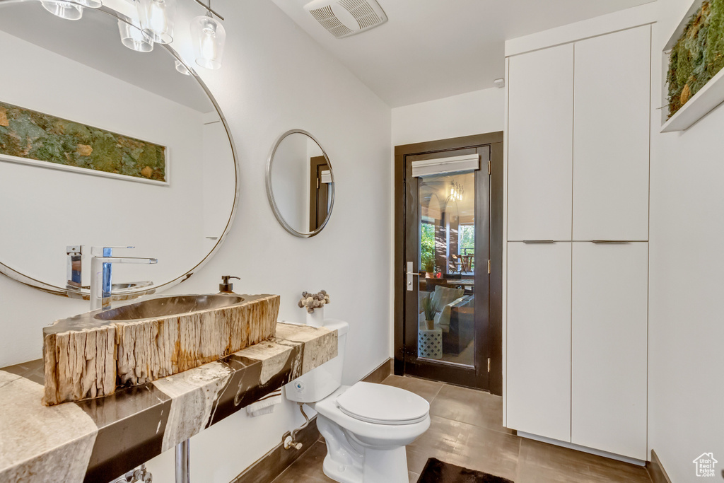 Bathroom featuring visible vents, toilet, and vanity
