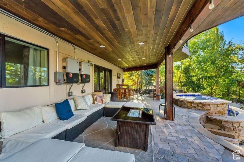 View of patio / terrace with an outdoor hangout area, outdoor dining space, and an in ground hot tub