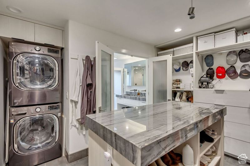 Laundry area with stacked washer / dryer and laundry area