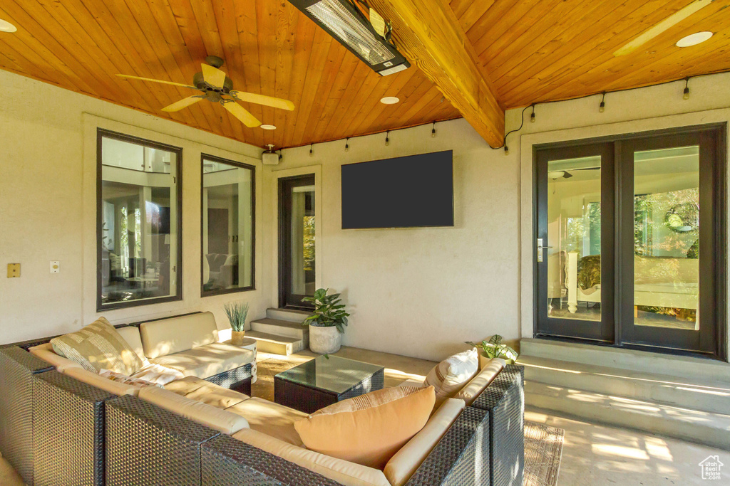 View of patio with entry steps, outdoor lounge area, and ceiling fan