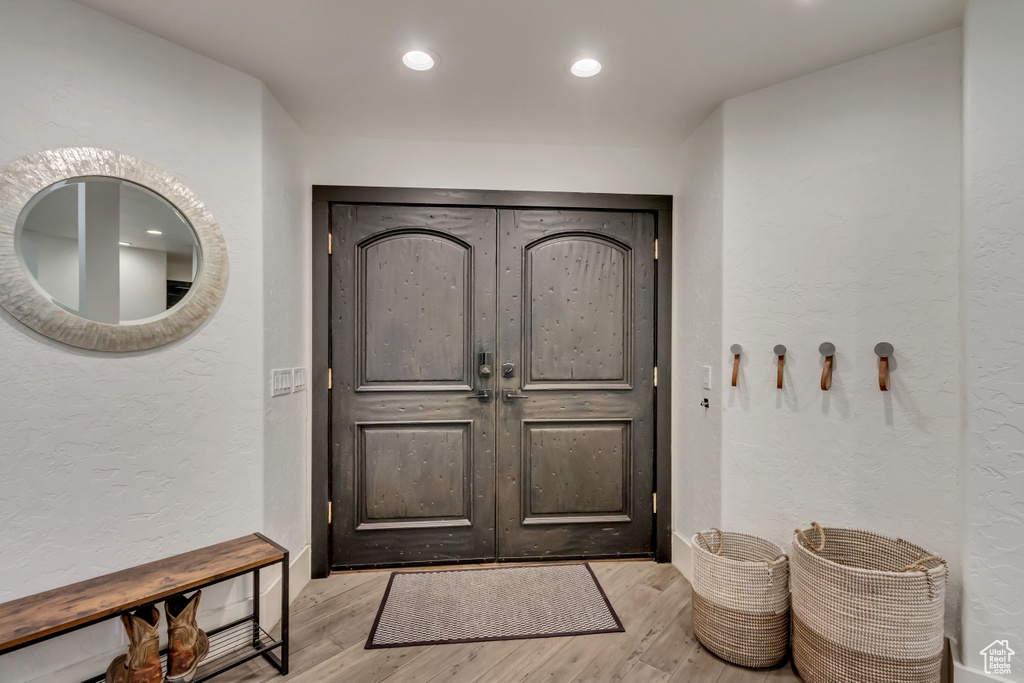 Entryway featuring recessed lighting, a textured wall, and wood finished floors