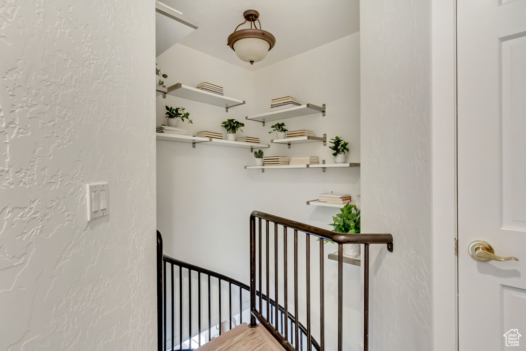 Stairway featuring a textured wall