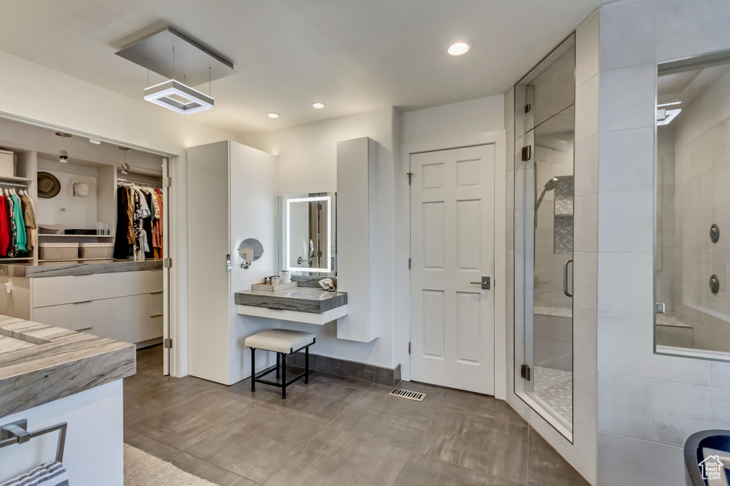 Full bathroom featuring visible vents, recessed lighting, vanity, a stall shower, and a spacious closet