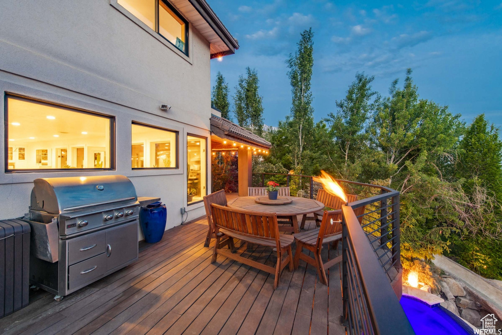 Wooden terrace with grilling area and outdoor dining area