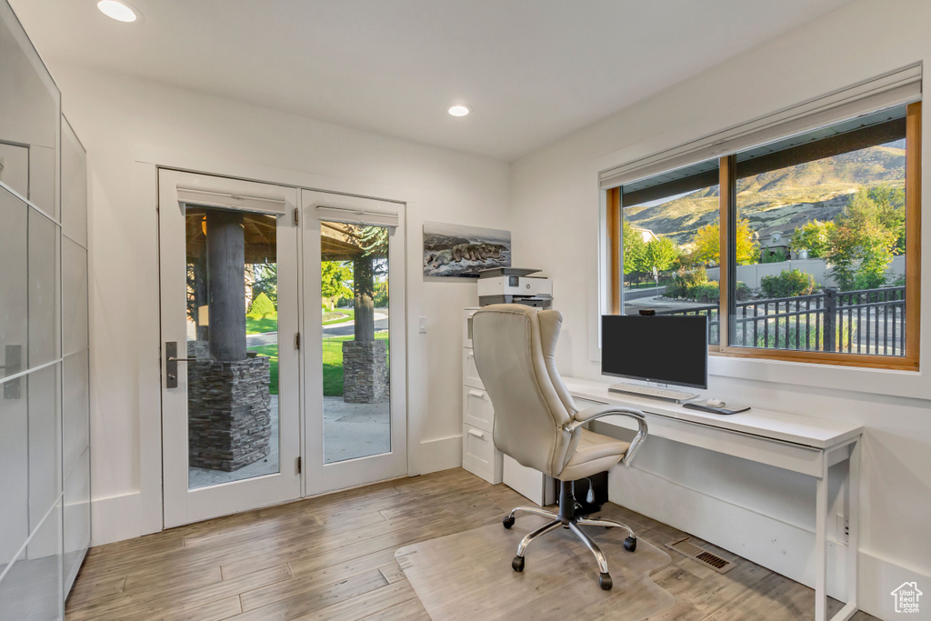 Office area featuring a wealth of natural light, light wood-style floors, and recessed lighting