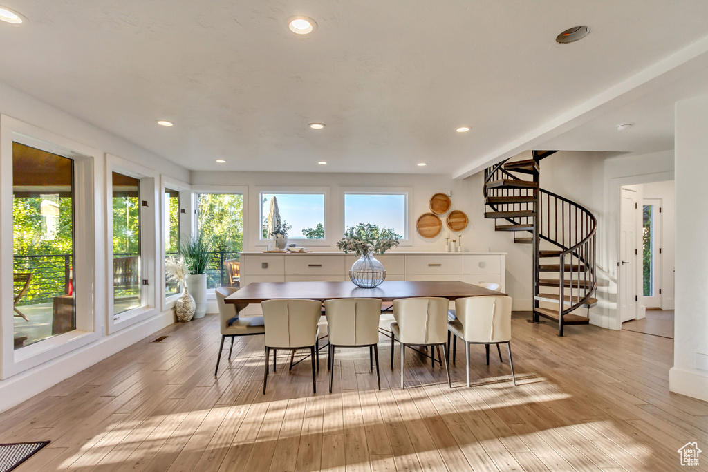 Dining room with hardwood / wood-style flooring, stairs, and recessed lighting