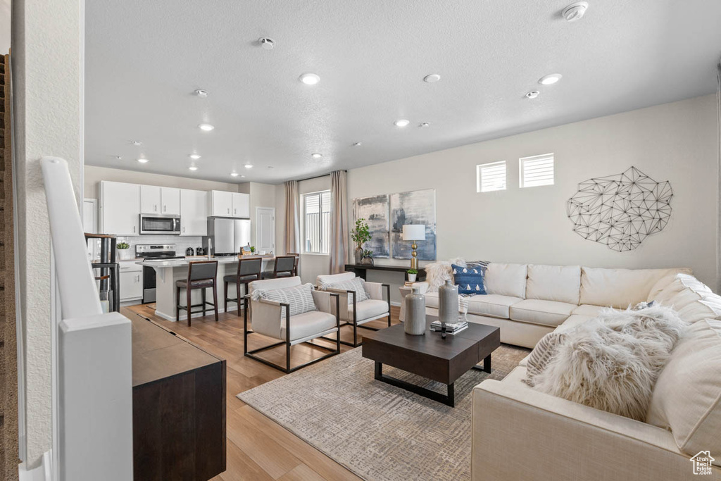 Living room featuring light wood-style floors and recessed lighting