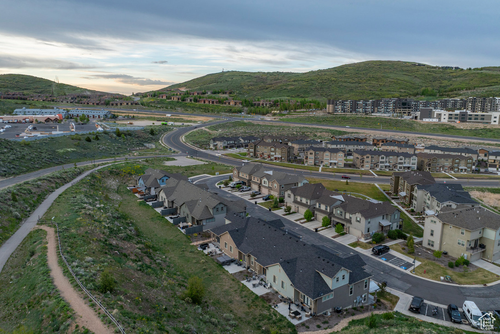 Aerial overview of property\'s location with a mountainous background and nearby suburban area