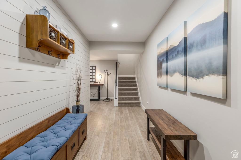 Hall with stairway, light wood-style floors, baseboards, and recessed lighting
