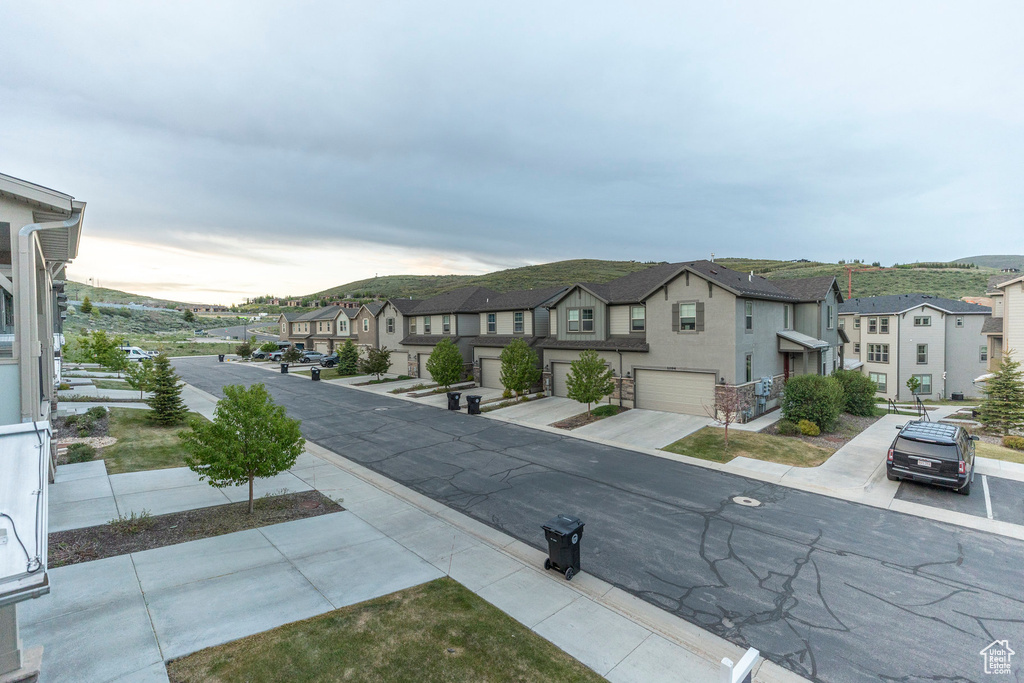 View of asphalt street featuring a residential view
