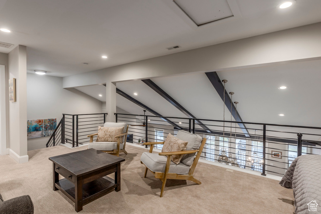 Carpeted living room with recessed lighting and lofted ceiling