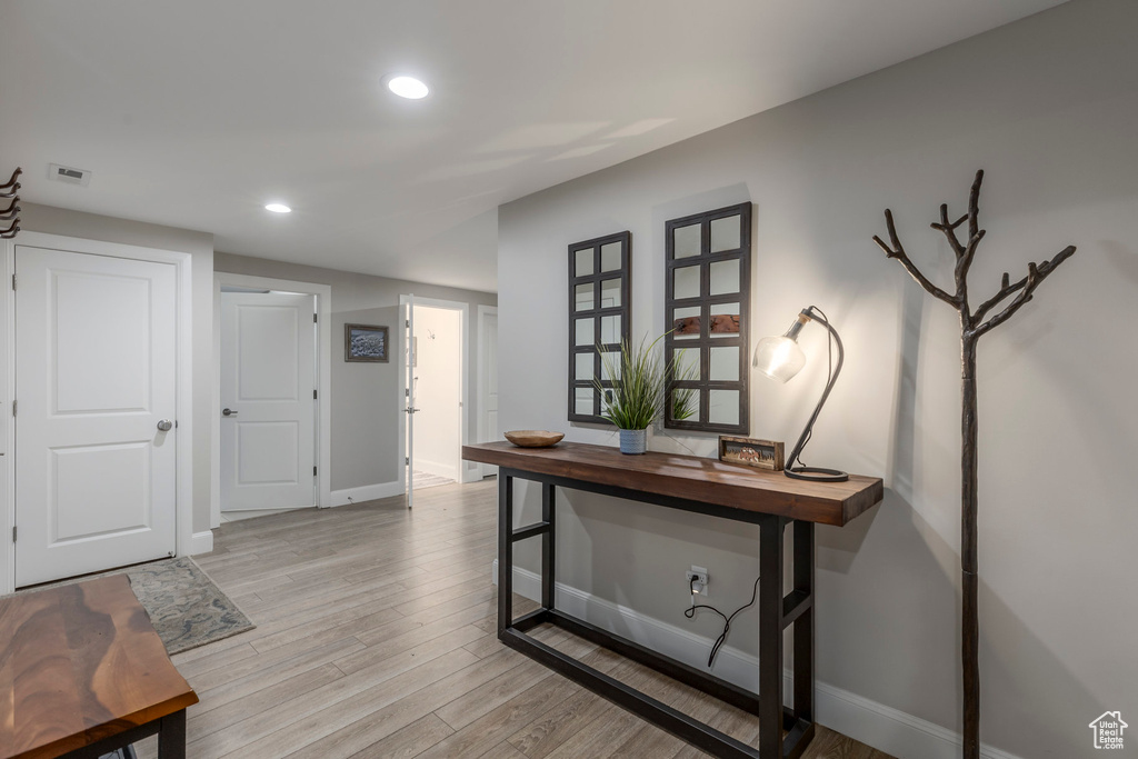 Foyer with light wood-style flooring, baseboards, and recessed lighting