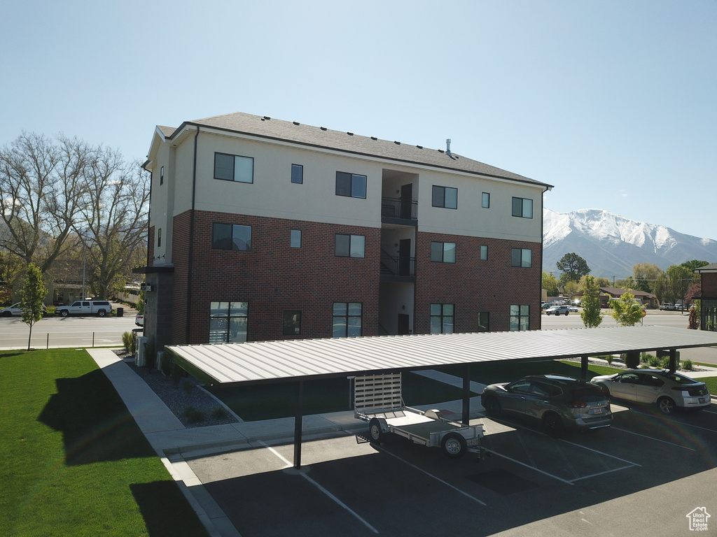 Exterior space with a mountain view and covered and uncovered parking