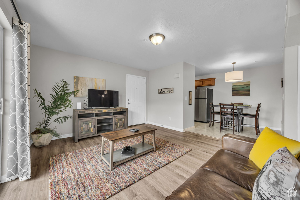 Living room featuring baseboards and light wood-style floors