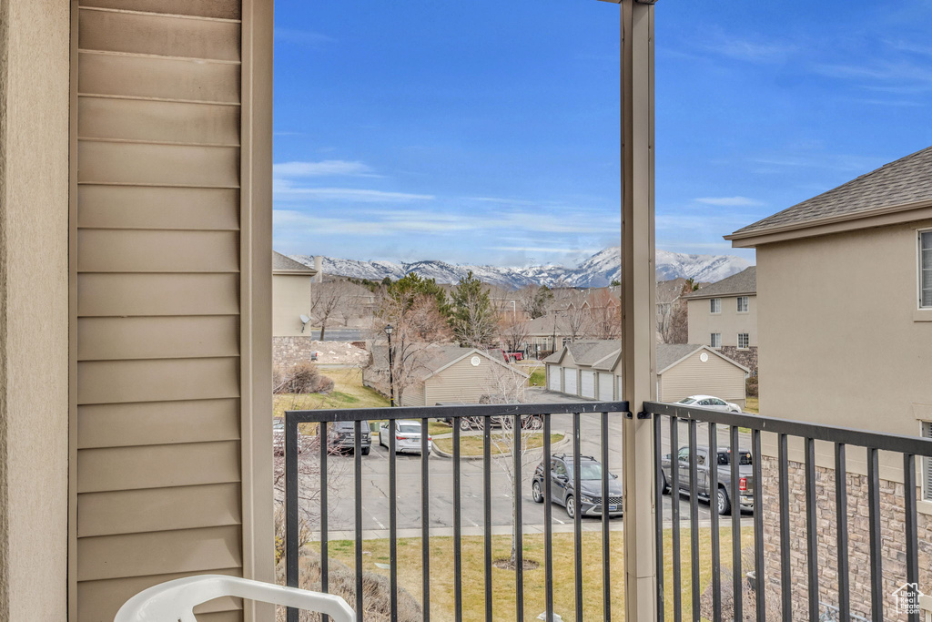 Balcony featuring a residential view and a mountain view