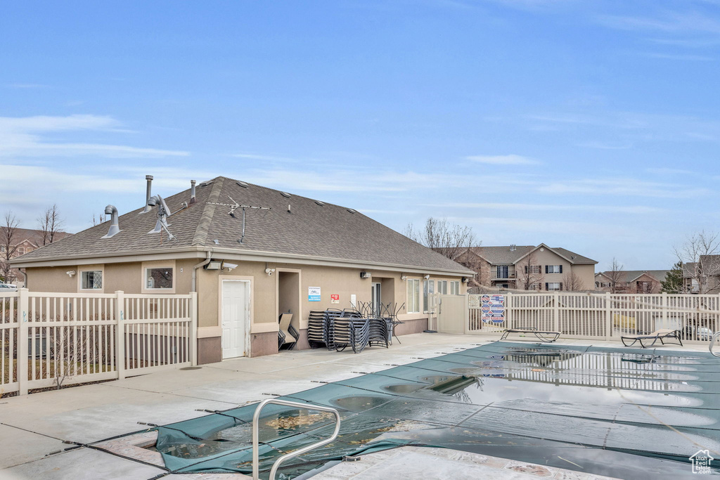 Pool featuring fence and a patio