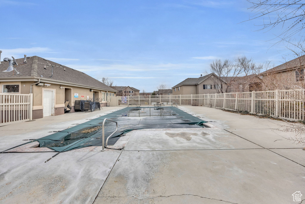 Pool with a fenced backyard and a patio