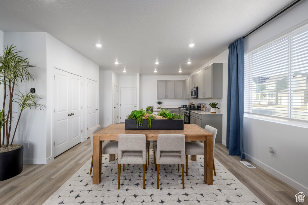 Dining space with recessed lighting, light wood-style floors, and visible vents