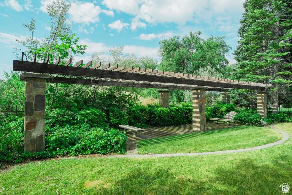 Surrounding community with a pergola and a lawn