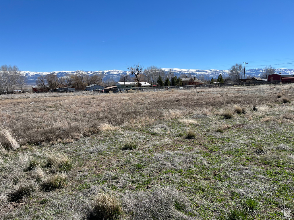 View of yard featuring a rural view and a mountain view