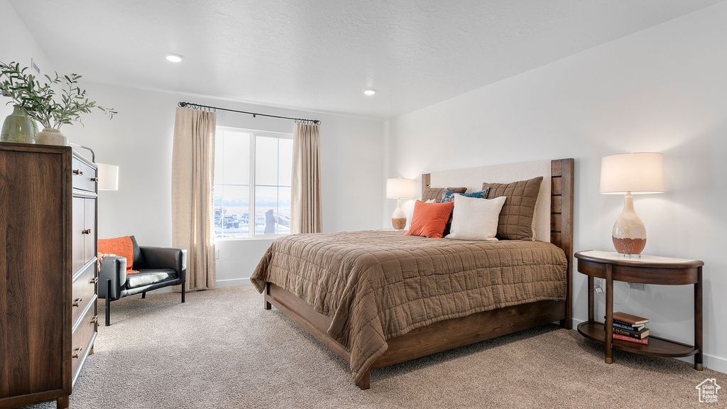 Bedroom featuring light carpet, baseboards, and recessed lighting