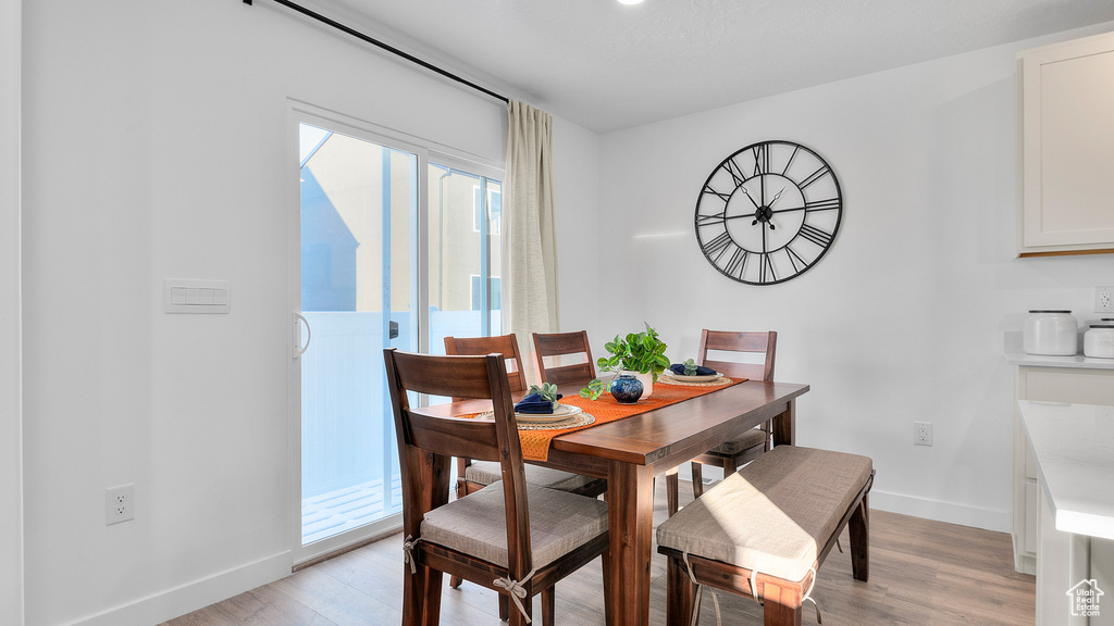 Dining area featuring light wood finished floors and baseboards