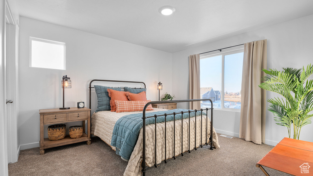 Bedroom featuring carpet floors, baseboards, and visible vents
