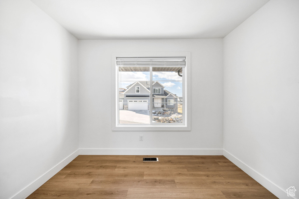 Spare room featuring baseboards, visible vents, and light wood-style flooring