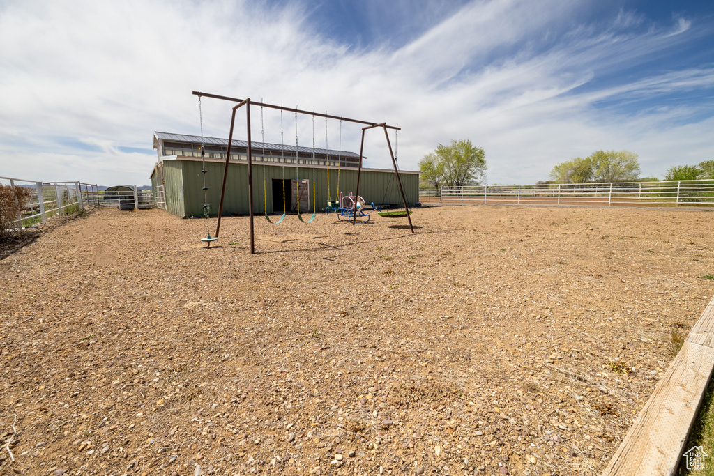 View of yard featuring fence and an outbuilding