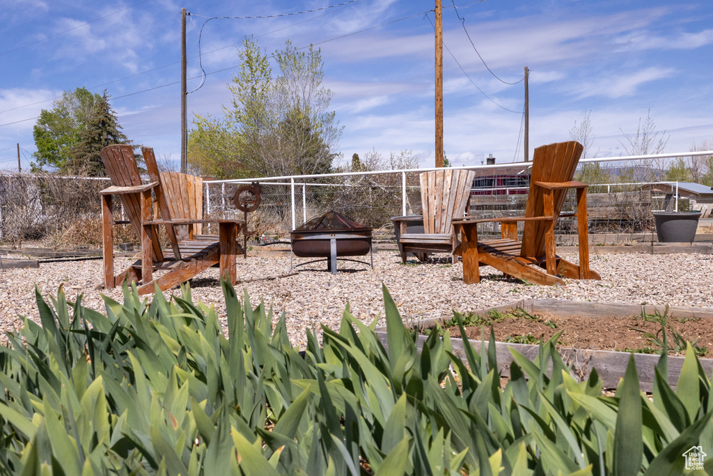 View of playground featuring an outdoor fire pit
